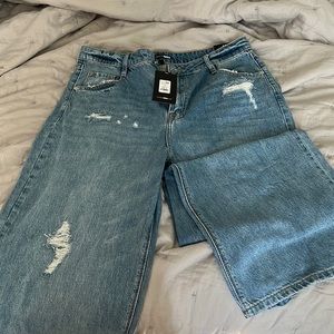 Jeans . Straight loose fit jeans . Rips . Brand new never worn.